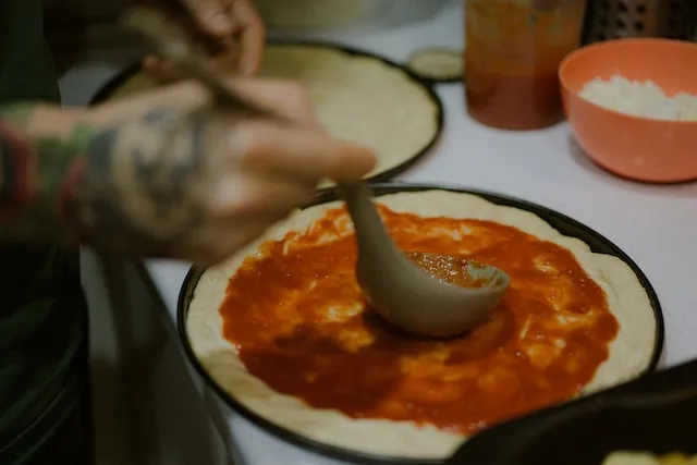 Stainless steel spoon with tomato sauce